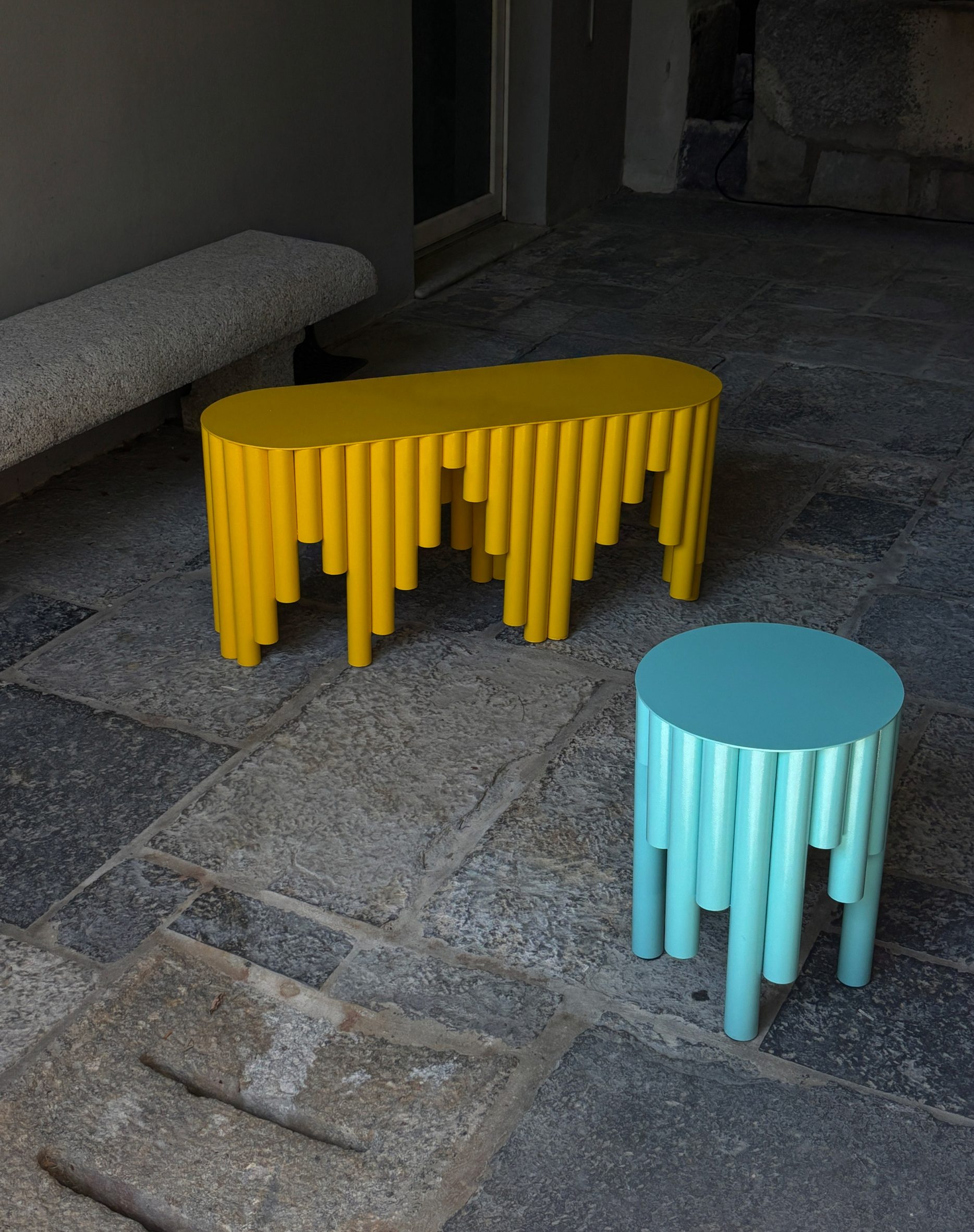 Yellow and blue bench and stool made from metal tubing